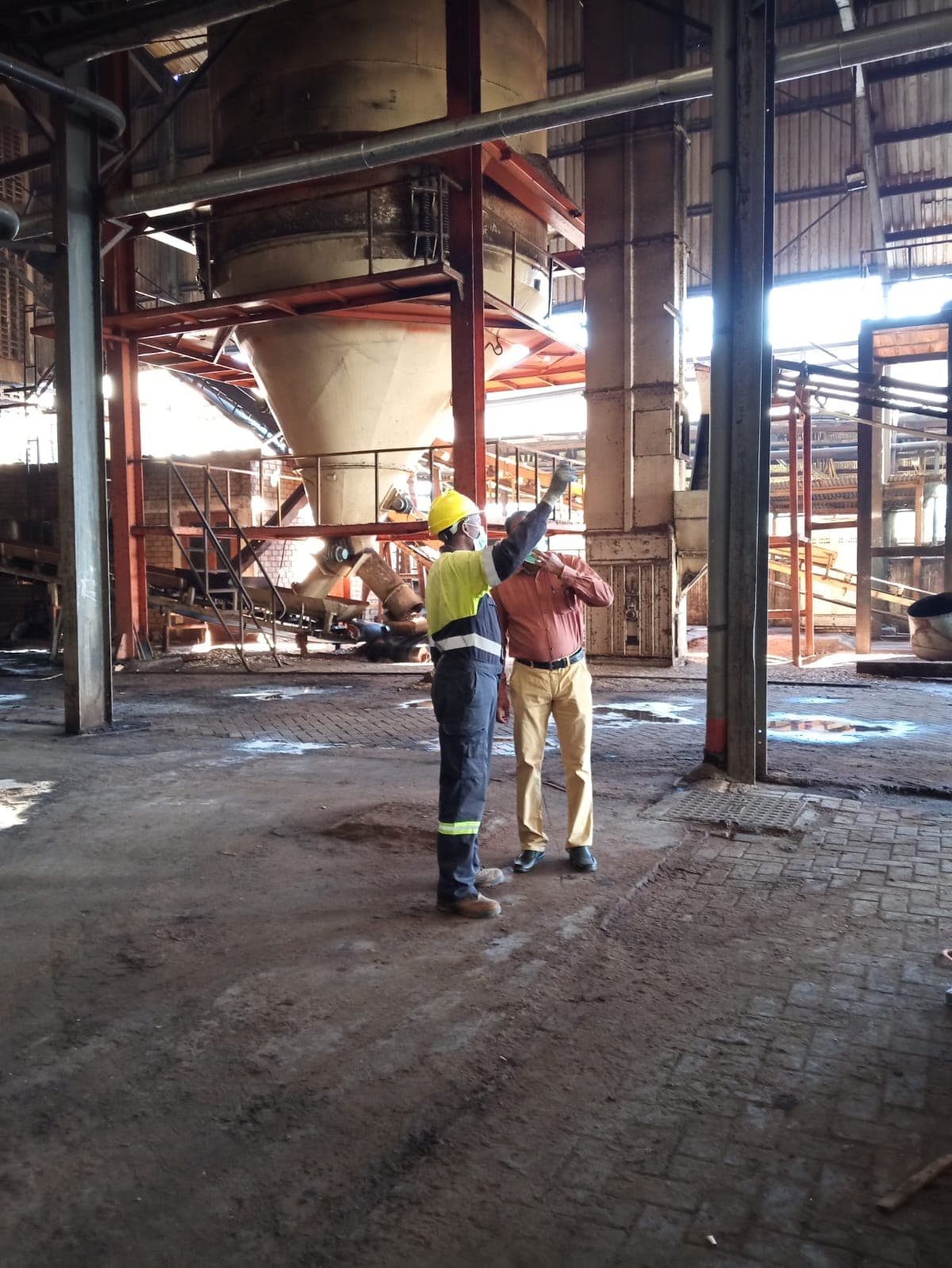 A SEEL technician in protective equipment inspecting process equipment inside a plant